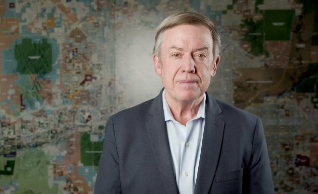 Michael Crow Fulton Center Michael Crow stands in front of a valley map in the Fulton Center.