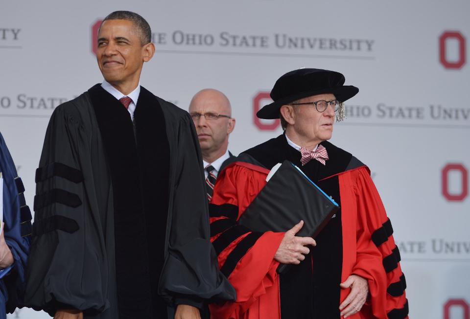 US President Barack Obama and Ohio State University President Gordon Gee arrive for the commencement ceremony at Ohio State University on May 5, 2013 in Columbus, Ohio.