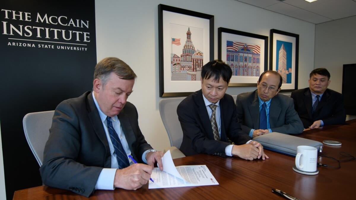 ASU President Michael Crow and representatives of the Vietnam Ministry of Science and Technology sign a letter of intent