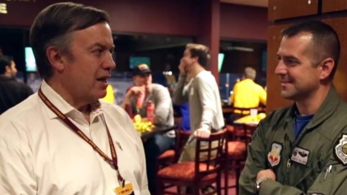 ASU President Crow visits with a military veteran during Salute to Service 2016.