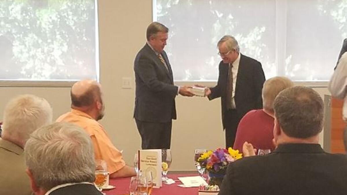 ASU President Michael Crow presents a Sun Devil Service Award